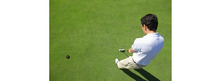 man putting on a putting green