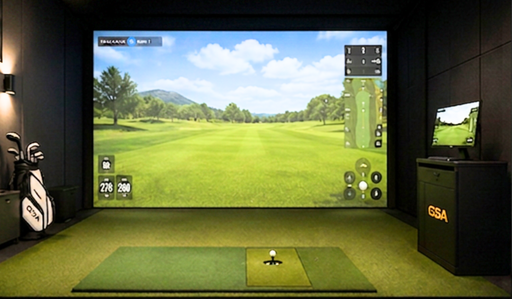 Indoor golf simulator setup with screen displaying a golf course using the GSA Auto Tee Up system.