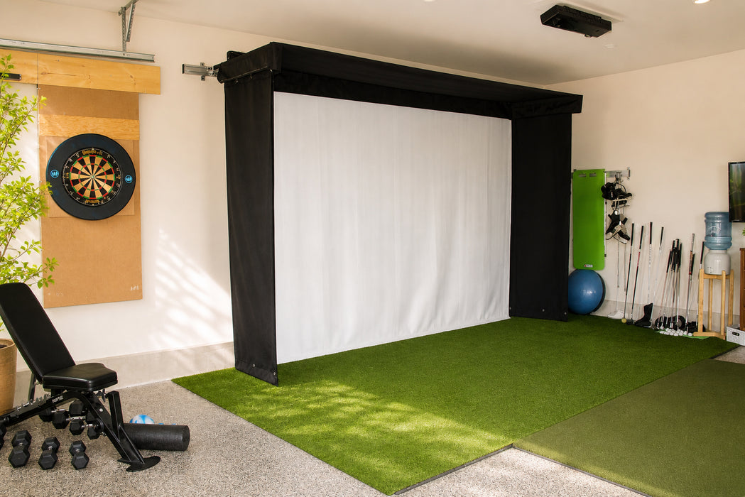 Indoor golf simulator setup with Vanish Lite, turf, and equipment.